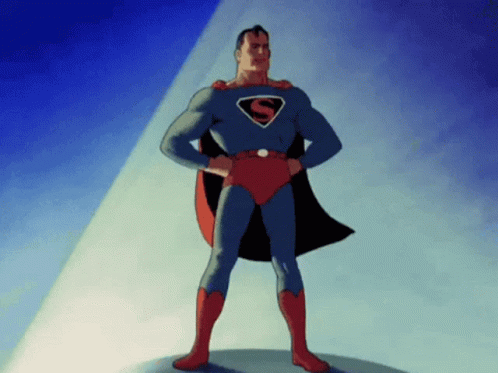 man in superman costume with cape standing against a brightly colored wall