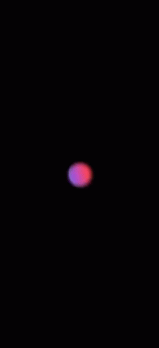 a black background with a blue light and a pink ball on it