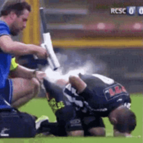 a man on the field after being hit by another player