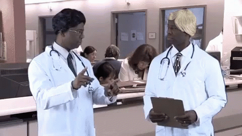 two doctors in white lab coats are looking at soing