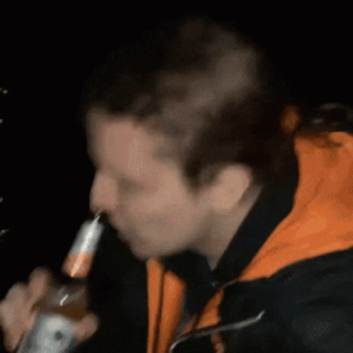 a man smoking in the dark with the lighter in his mouth