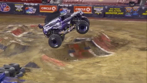 a man riding on the back of a monster truck in a pool