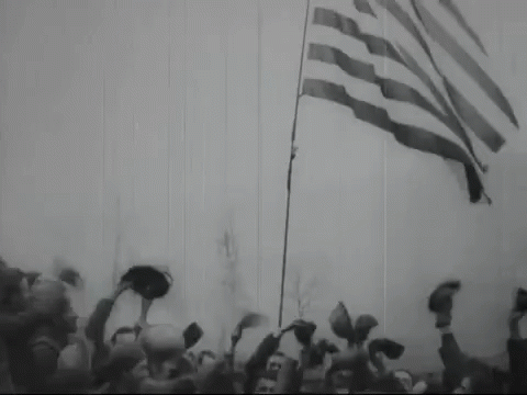 the flag being flown in front of an audience