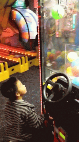 a man in striped shirt driving a video game
