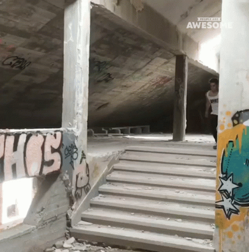an empty parking garage filled with stairs and graffiti