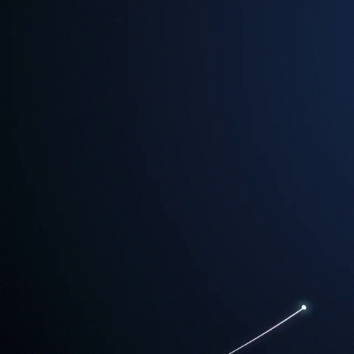 a plane flying in the air in the dark