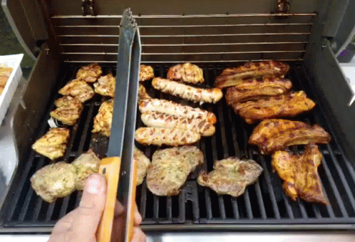 some food on a grill being prepared for sale