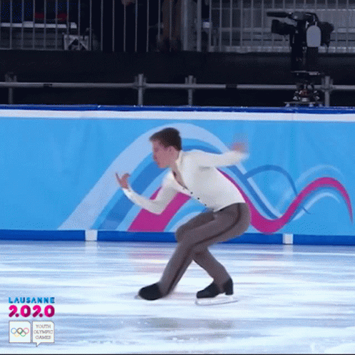 a man is skating on ice with one leg bent