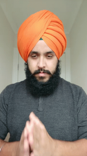 a man with a turban on his head and hands