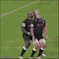 two football players are touching noses while standing