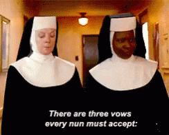 two people standing next to each other wearing nun robes