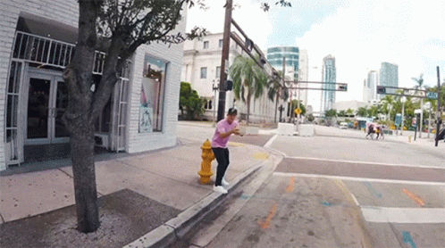 a guy on a skateboard doing a trick on a street