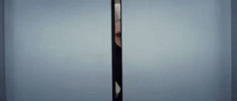 a tall pole stands in the corner by the wall