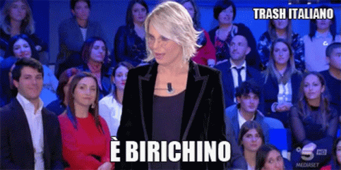a woman is standing in front of a crowd with the words e birchino