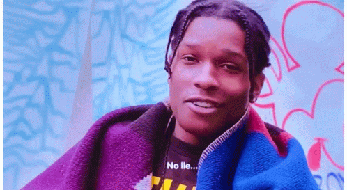a young man with dreadlocks is wearing a jacket