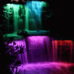 an artistic po of a waterfall lit by color