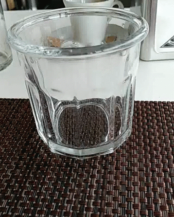 the glass is clear and sits on a table