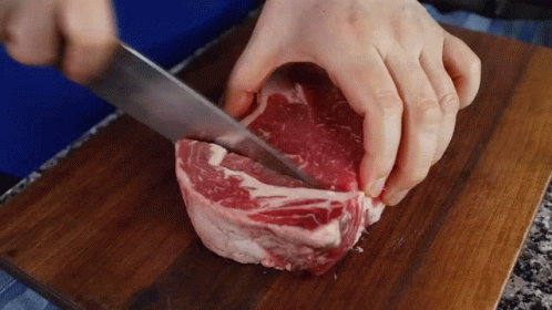a person using scissors to cut up some meat