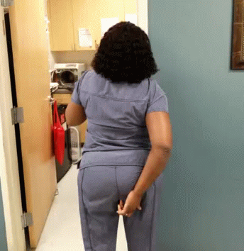 a woman standing in the hallway with her hands on her hips