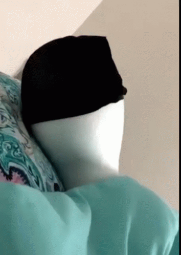a white and black mannequin wearing a head scarf
