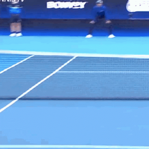 two men playing tennis on a tennis court