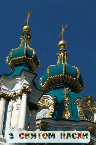 two spires atop of a building with an ornamental decoration