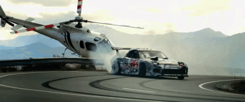 an image of a car that is driving next to a helicopter
