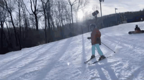 a skier on a snowy hill at a resort