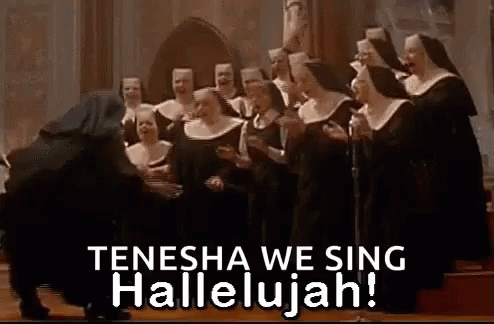 a choir of people in large black dress and singing with a choir member with a choir microphone