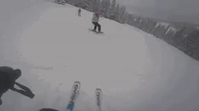 people riding skis and snowboards on top of a snowy slope