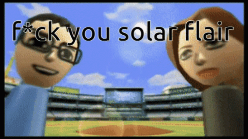 two blue dolls with solar flarers in front of a stadium