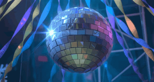 disco ball in the middle of a stage filled with streamers