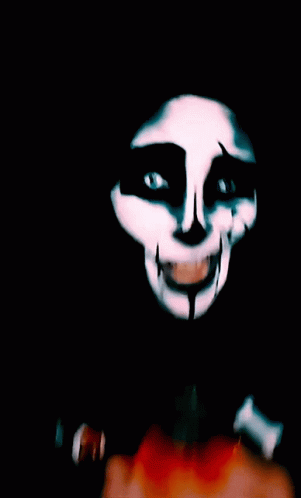 an animated woman with painted face on a dark background