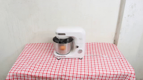 a blue and white table cloth with a mixer on it