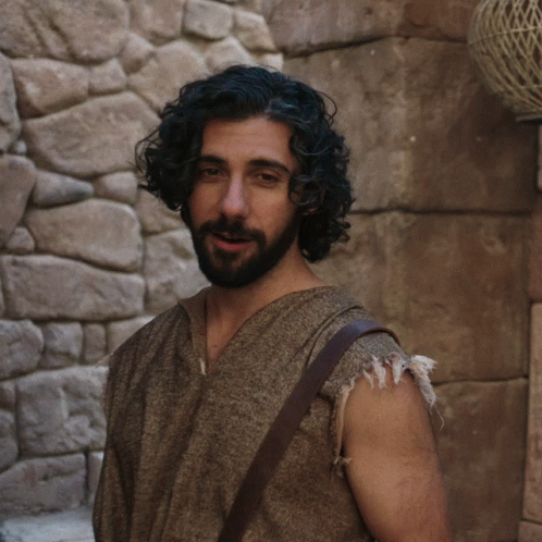 man in roman costumes posing for camera on a wall