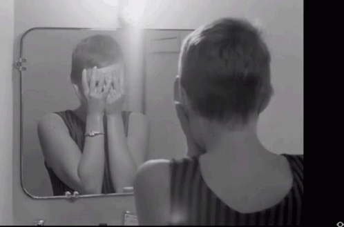 a person in front of a mirror brushing their teeth