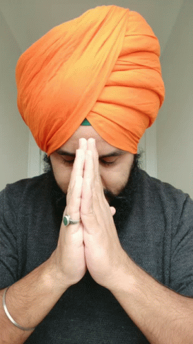 man wearing a turban covering his face