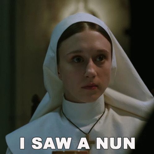 a woman wearing a nun costume in a dark room
