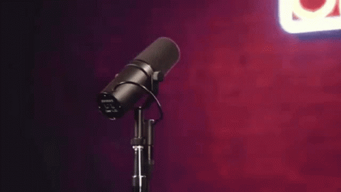 a microphone and some purple walls
