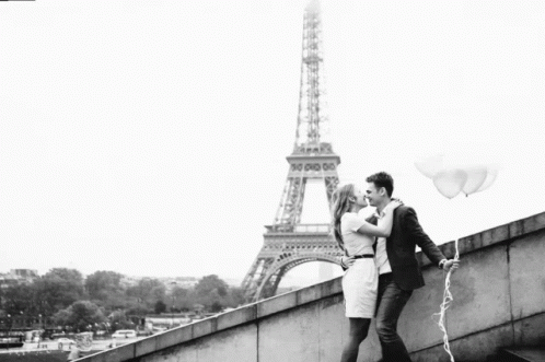 black and white image of couple in front of the eiffel tower