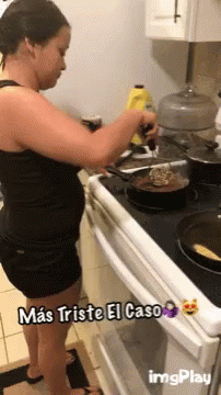 a woman in a black dress washing her dishes