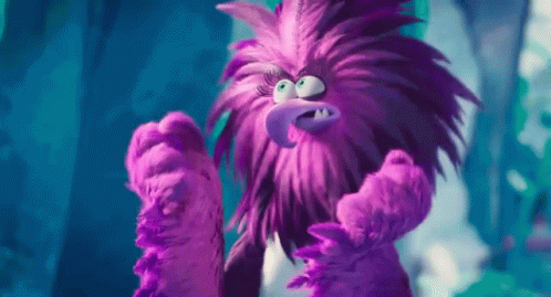 the angry purple stuffed animal looks like he is ready to jump
