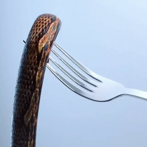 a fork and two small pieces of bread are attached to a silver fork