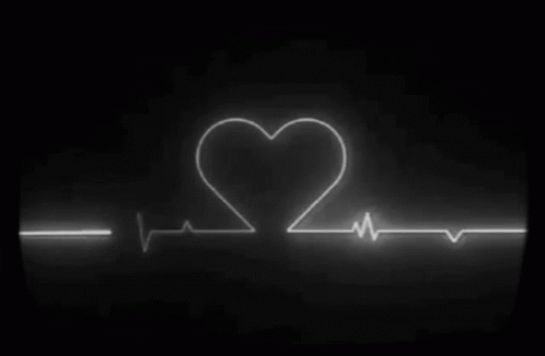 a neon heartbeat with a heart on it