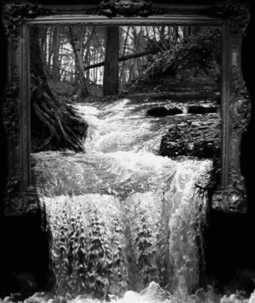 water rushes through a river in front of a framed mirror