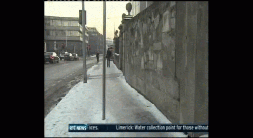 the sidewalk is dirty of snow as people walk