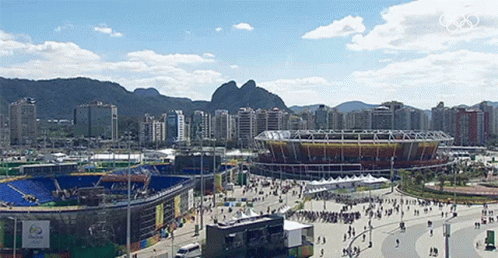 a beautiful view of a stadium with mountains in the background
