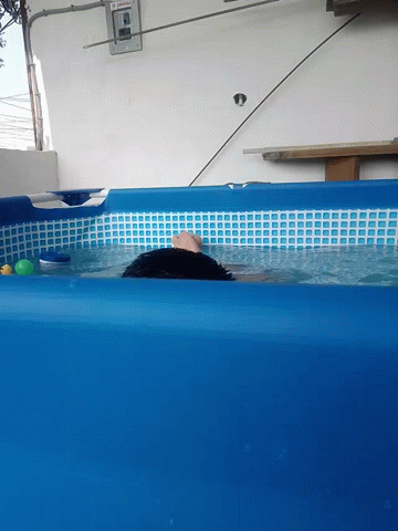 there is a man in the water inside the pool