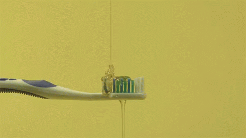 two toothbrushes hanging on a rack in the water