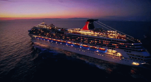 an illuminated cruise ship sailing in the water
